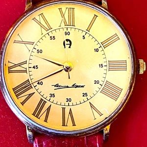 Slim Aigner watch with faux red, snakeskin band.